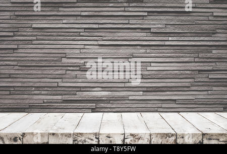 Empty wood table top with brick wall background. Stock Photo