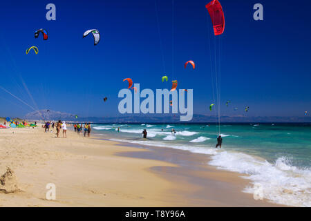 TARIFA (COSTA DE LA LUZ, PLAYA DE BOLONIA), SPAIN - JUNE, 18. 2016: Kite surfers on the beach in Spain Stock Photo