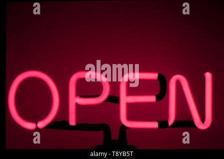 A neon "open" sign glowing red Bar open light neon sign night store red pink glowing  background Stock Photo