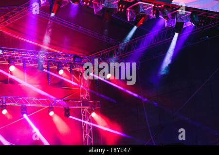 Spotlights, red and blue beams of lights above stage during concert event festival Stock Photo