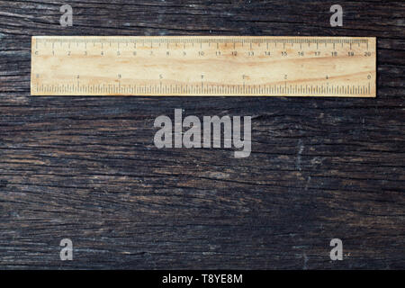 wooden rulers in centimeter and inch on old wood rustic background nature eco environment concept idea Stock Photo