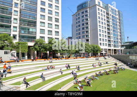 Office workers taking a break in the sun at Sheldon Square, Paddington, London, UK Stock Photo