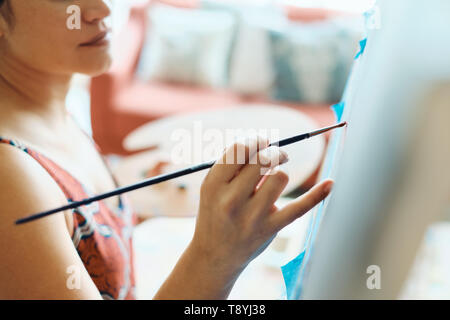 Young Woman As Artist Painting At Home For Art Creativity Stock Photo