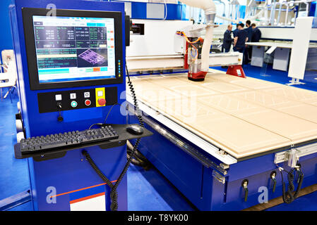 Milling and engraving CNC center with automatic tool change for furniture in the factory Stock Photo