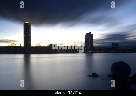 Bonn city skyline seen from rhine river, long exposure clouds, at dusk Stock Photo