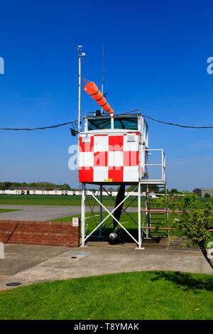 Control tower and windsock at the former RAF Breighton airfield in the East Riding of Yorkshire. Home to the Lincoln Aero Club and the Real Aeroplane 
