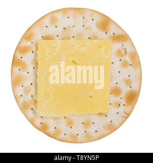 Cheddar cheese on a round cracker or biscuit, UK. Carrs table water biscuit shot from above and cut out or isolated on a white background. Stock Photo