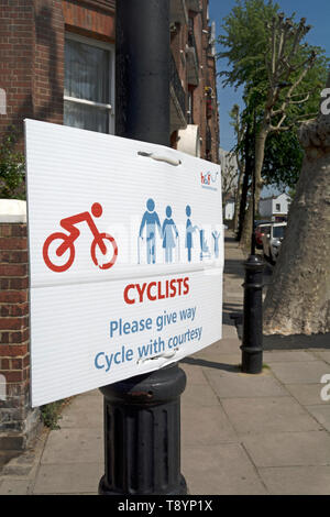 hammersmith and fulham council sign on the thames path asking cyclists to give way and cycle with courtesy, london, england Stock Photo