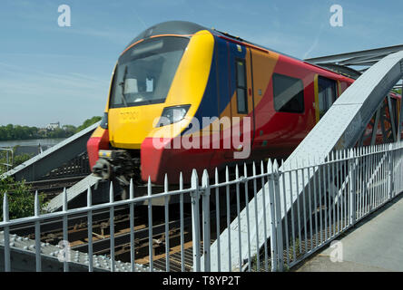 a south western railway train crosses barnes bridge, on the river thames in southwest london, as it enters barnes station Stock Photo