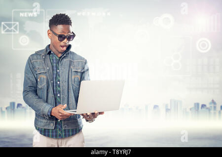 Portrait happy successful young man with laptop computer. Connecting, device concept Stock Photo