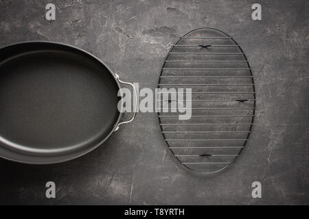 Empty Gray Nonstick Baking Dish with Handles on Dark Stone Surface. Culinary Background. Stock Photo