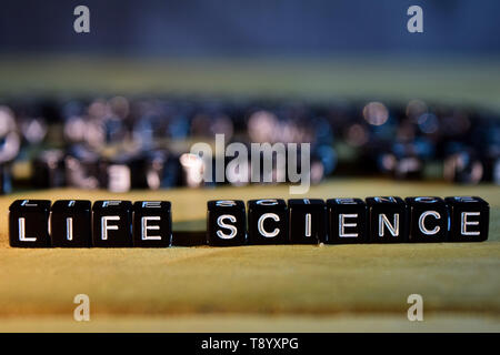 LIFE SCIENCE concept wooden blocks on the table. With personal development, education and motivation concept on blurred background Stock Photo