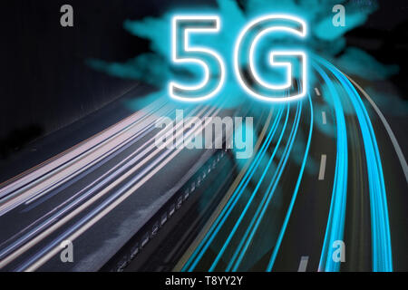 5G network wireless systems and internet shown with blue trail lights on highway. Stock Photo