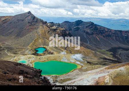 View of Emerald lakes from Tongariro Alpine Crossing hike with clouds above, North Island, New Zealand. Stock Photo