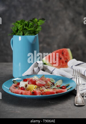 Plate with delicious watermelon salad on table Stock Photo