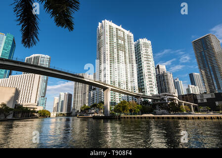 Miami, FL, USA - April 19, 2019: View of downtown financial and residential buildings and Brickell key on a spring day with blue sky and green waters  Stock Photo