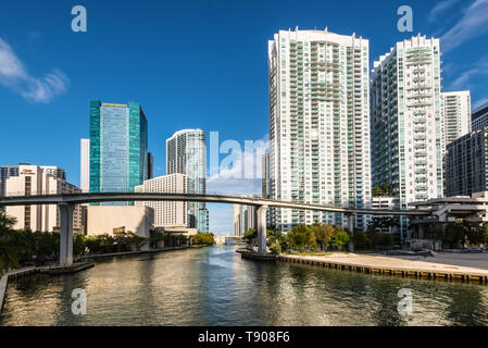 Miami, FL, USA - April 19, 2019: View of downtown financial and residential buildings and Brickell key on a spring day with blue sky and green waters 