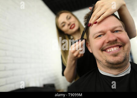 Hairdresser Combing Male Hair in Beauty Salon Stock Photo