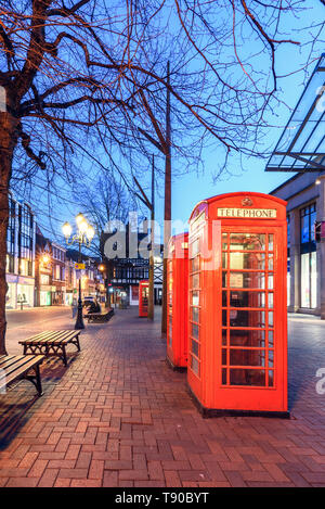 The red phone box is a familiar sight on the streets of the United Kingdom. This box is situated in Chester city, UK. Stock Photo