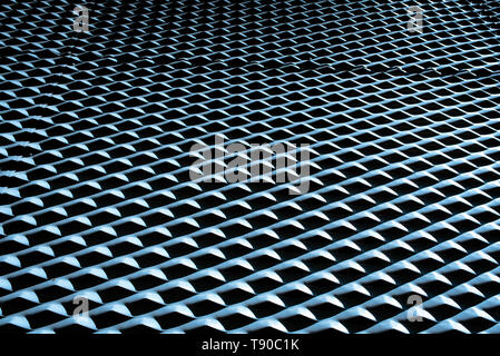 Industrial background with metallic texture illuminated with strong light and intense shadows and repetitive pattern. Stock Photo