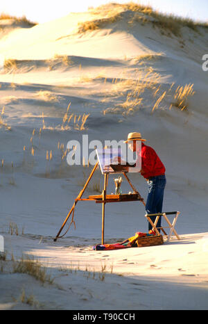 An artist at work in the sand dunes of Cape Cod, in Truro, Massachusetts, USA Stock Photo