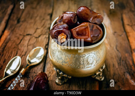 Dried date palm fruits or kurma, ramadan food. Beautiful bowl full of date fruits symbolizing Ramadan. Close -up. Stock Photo