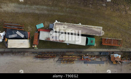 Scrap machinery and trucks on yard, top down aerial view Stock Photo