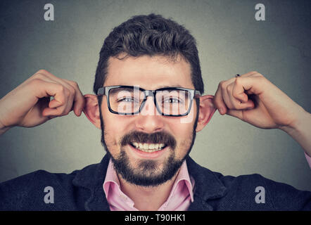 Funny young man making silly faces Stock Photo
