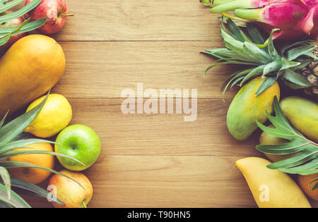 Group of fruits on wood table with space background Stock Photo