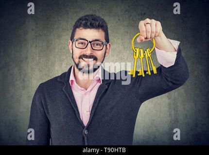 Handsome happy man holding old keys Stock Photo