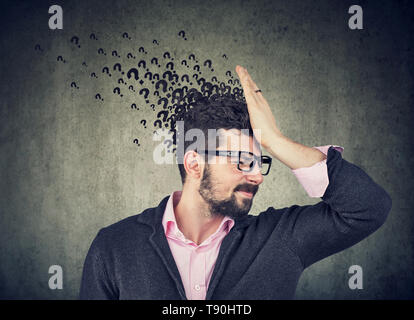 Man with worried stressed face expression and many questions Stock Photo