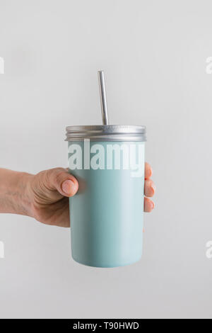 Reusable blue jar with metal straw for summer drinks. Individual use. Save the planet. Zero waste concept. Plastic free. Vertical shot. Stock Photo