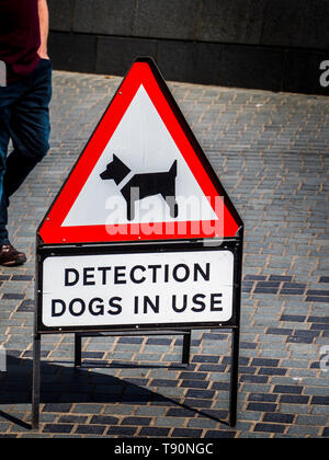 Detection Dogs in Use Sign - warning about the use of dogs trained to use its sense of smell to detect explosives or illegal drugs, Stock Photo