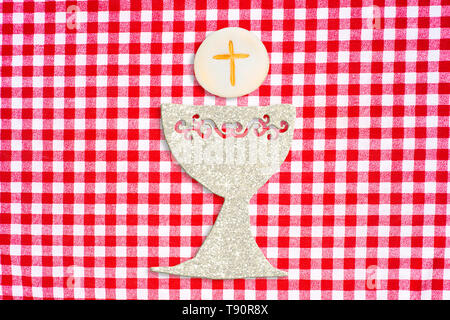 First holy communion invitation card.Silver chalice on cute background. Stock Photo