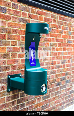 Water refill point installed onto a brick wall in central London, UK (St James's Market) Stock Photo