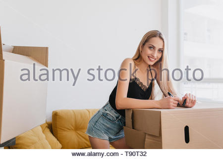 Female Blonde Hair Wearing A Yellow Vest Pink Shorts And Blue
