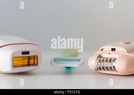 Razor, epilator and IPL epilator on white background. Hair removal concept Stock Photo