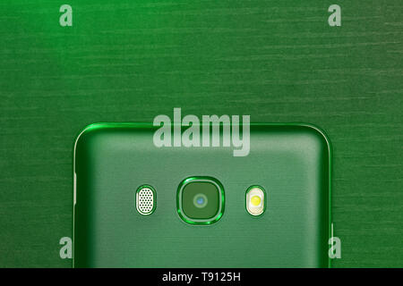 Close-up view of the top of the black smartphone on camera and microphone with green. Macro horizontal photography Stock Photo