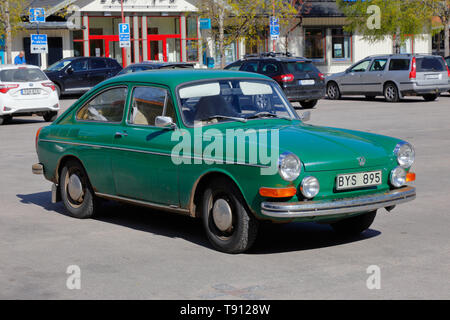 Rattvik, Sweden - May 14, 2019: Front and side view of a green 1972 model Volkswagen 1600 TE 311, Type 3 Fastback Sedan parked at the town square car  Stock Photo