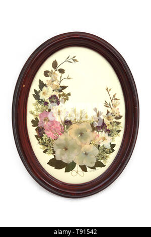 Dry Pressed Flowers in Oval Wooden Frame Stock Photo