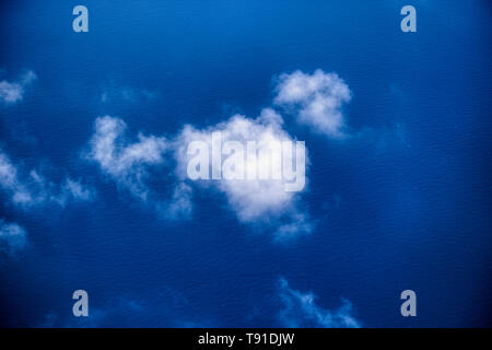 This unique image shows the Maldives photographed on a plane from above. you can see the sky and the clouds from the airplane Stock Photo