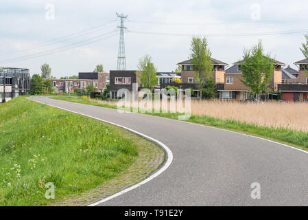 Empty curved road on a dam in the dutch countryside, Capelle Aan Den Ijssel, Netherlands Stock Photo