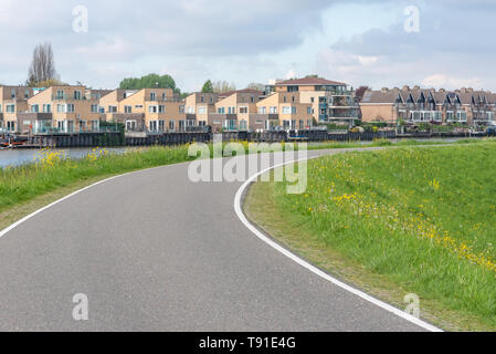 Empty curved road on a dam in the dutch countryside, Capelle Aan Den Ijssel, Netherlands Stock Photo