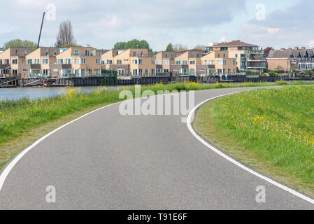 Empty curved road on a dam in the dutch countryside, Capelle Aan Den Ijssel, Netherlands Stock Photo