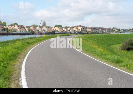 Empty curved road on a dam in the dutch countryside, Capelle Aan Den Ijssel, Netherlands Stock Photo