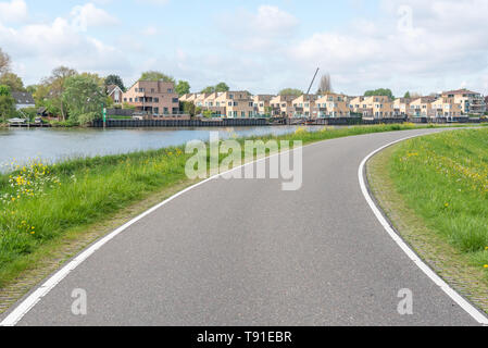 Empty curved road on a dam in the dutch countryside, Capelle Aan Den Ijssel, Netherlands Stock Photo