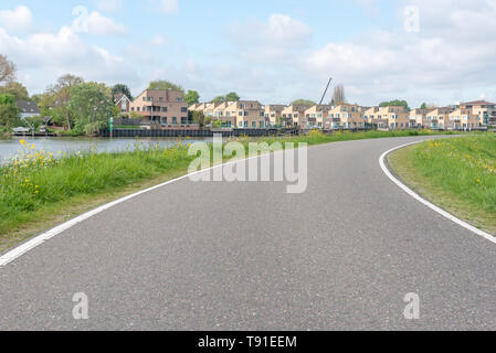 Empty curved road on a dam in the dutch countryside, Capelle Aan Den Ijssel, Netherlands Stock Photo