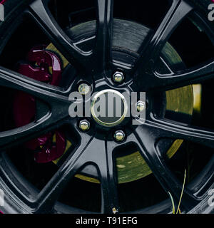 Perfectly suited for use on the street or at the track. Alloy wheel. Gloss black rim of luxury car wheel. Wheel and rim. Car wheel detail. Front or Stock Photo