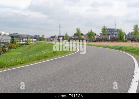 Empty curved road on a dam in the dutch countryside, Capelle Aan Den Ijssel, Netherlands Stock Photo