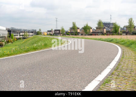 Empty curved road on a dam in the dutch countryside, Capelle Aan Den Ijssel, Netherlands Stock Photo